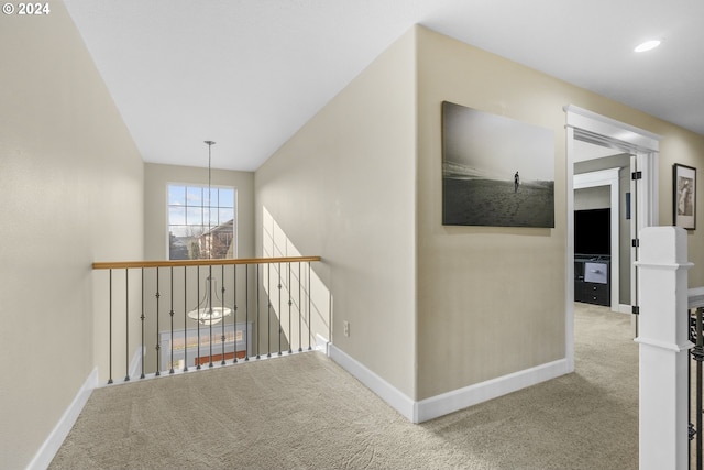 hall featuring light colored carpet