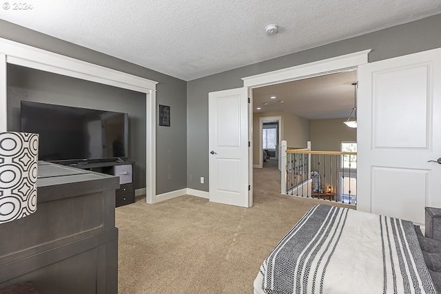 bedroom featuring carpet floors and a textured ceiling