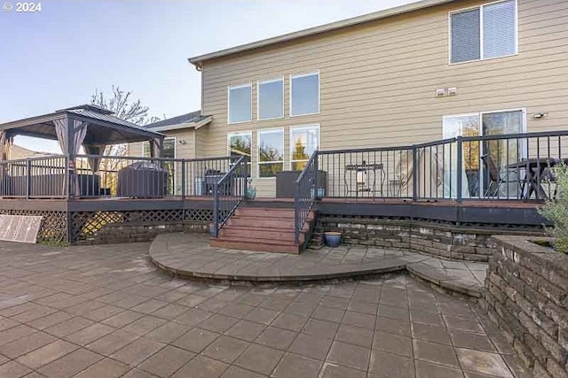 back of property with a gazebo, a patio area, and a deck