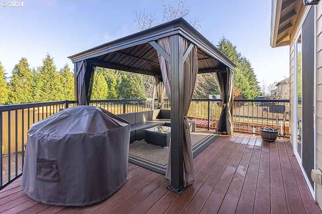 wooden terrace featuring a gazebo, area for grilling, and an outdoor living space