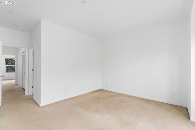 unfurnished room with light carpet