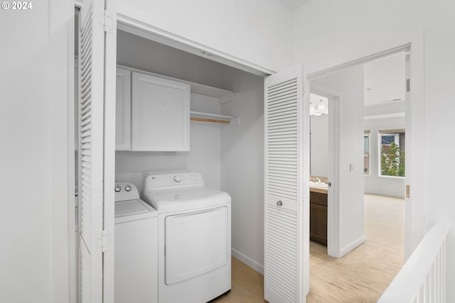 laundry room featuring cabinets, light carpet, sink, and washing machine and dryer