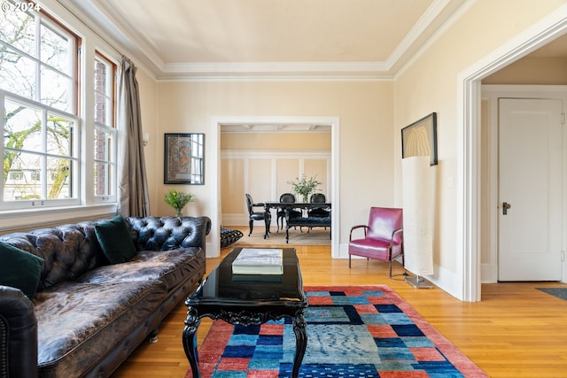 living room featuring wood-type flooring and ornamental molding