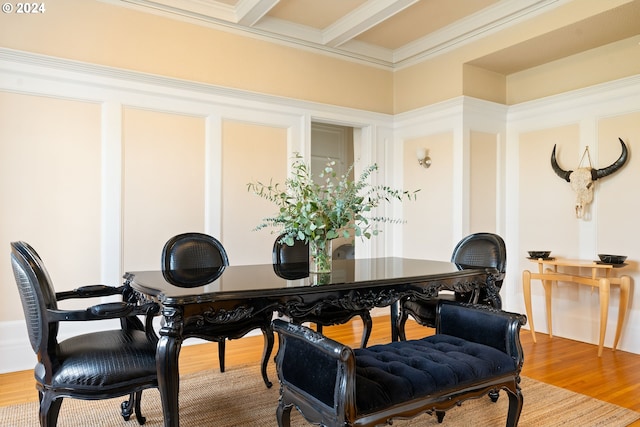 dining room featuring beamed ceiling, ornamental molding, and hardwood / wood-style flooring