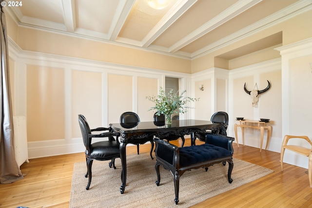 dining room with beamed ceiling, ornamental molding, and hardwood / wood-style flooring