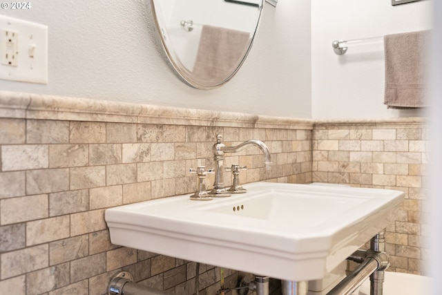 bathroom featuring tile walls and sink