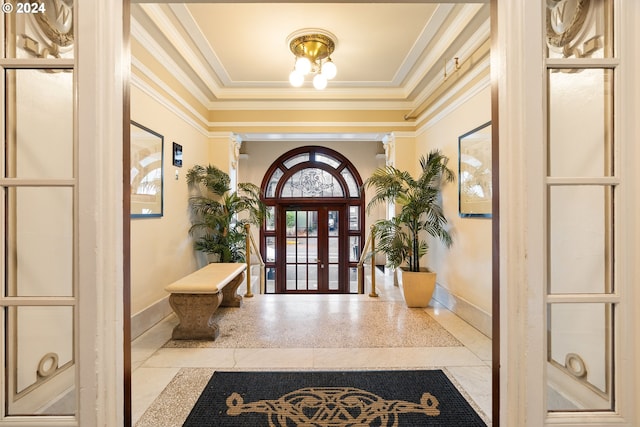 foyer featuring crown molding and french doors