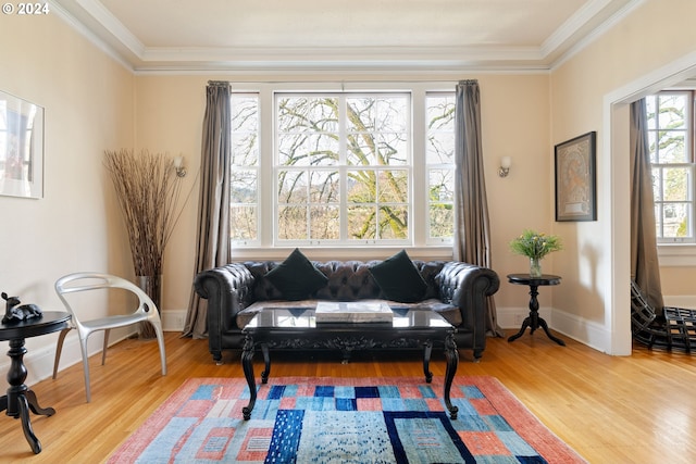 sitting room with ornamental molding, hardwood / wood-style flooring, and a healthy amount of sunlight