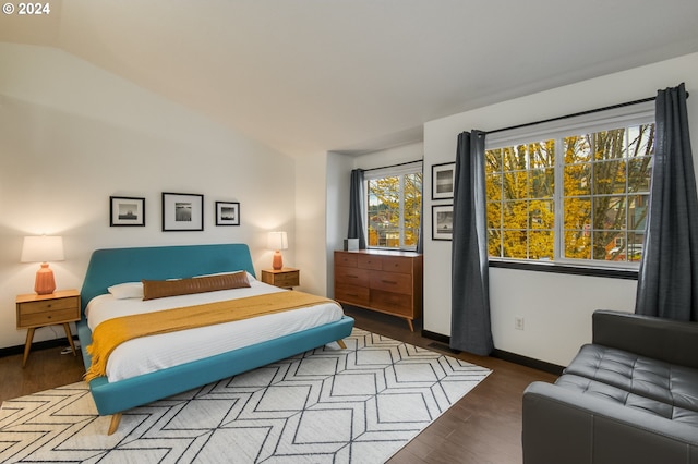 bedroom featuring wood-type flooring and lofted ceiling