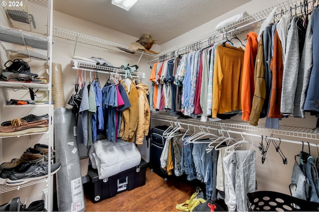 walk in closet with hardwood / wood-style flooring