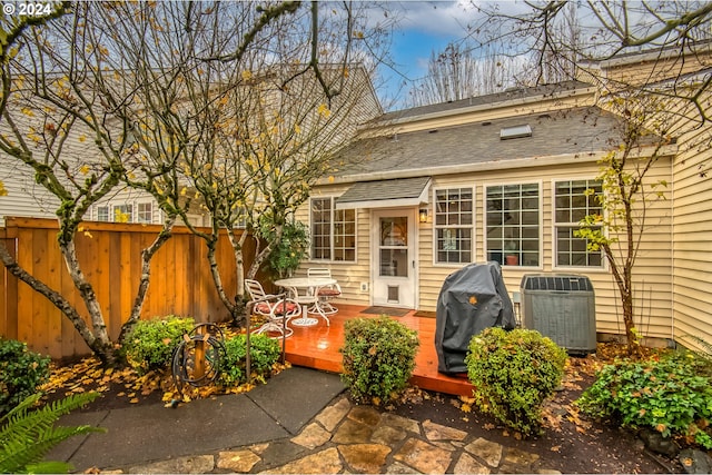 view of patio with grilling area, central AC unit, and a wooden deck