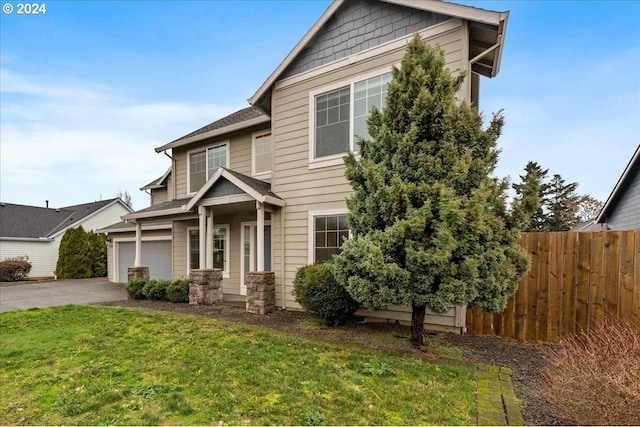 view of front of home featuring a garage and a front lawn