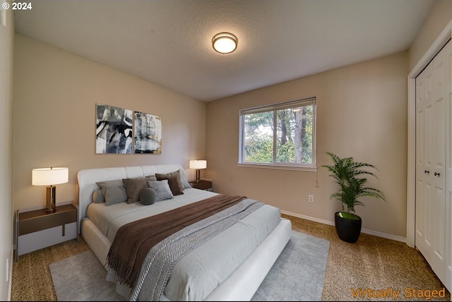 unfurnished bedroom featuring carpet, a textured ceiling, and a closet