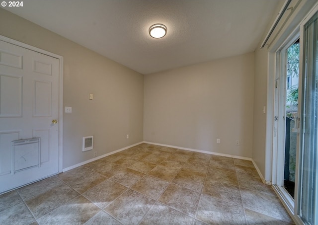 empty room with a textured ceiling