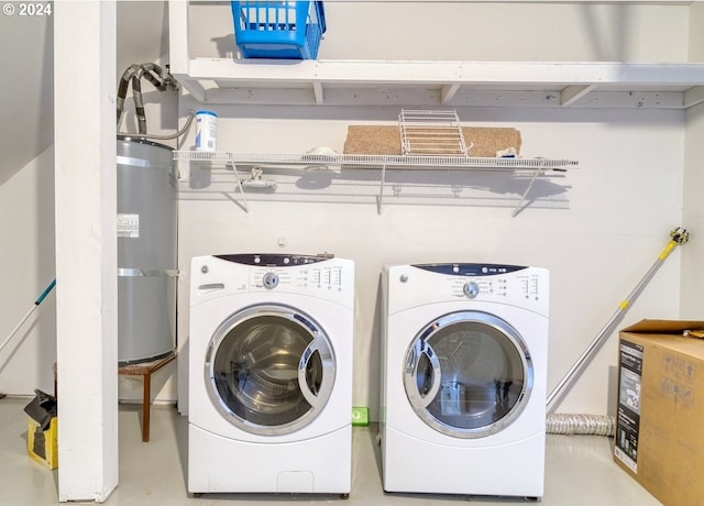 laundry room featuring water heater and washer and dryer