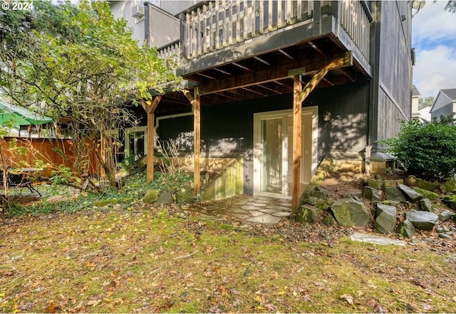 rear view of property featuring a balcony