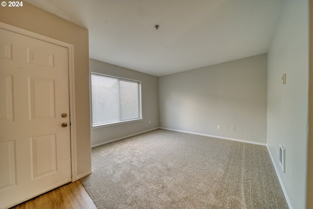 empty room featuring light carpet