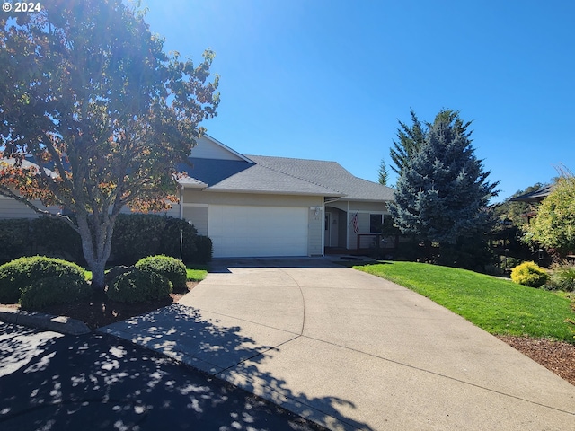 view of front of home featuring a garage and a front lawn