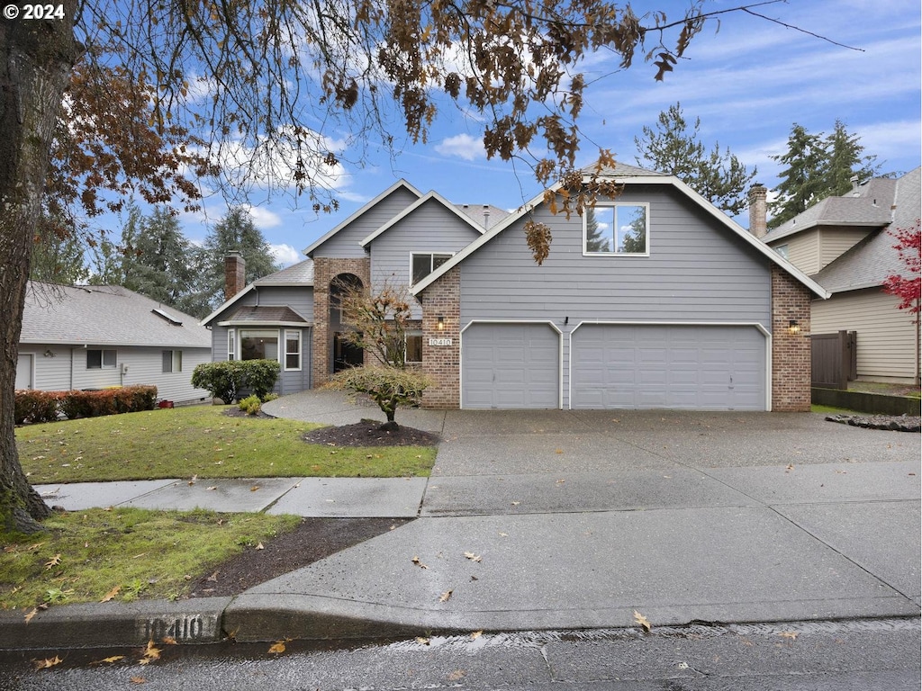 view of front of house featuring a garage and a front lawn