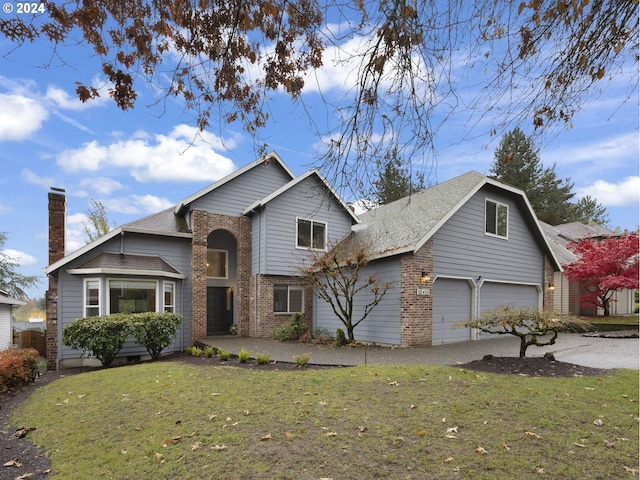 view of property featuring a front yard and a garage