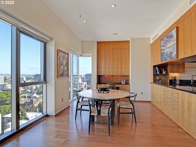 dining room featuring hardwood / wood-style flooring and sink