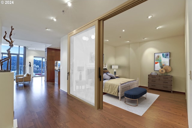 bedroom with dark hardwood / wood-style floors