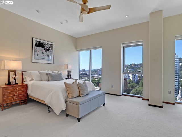 bedroom featuring ceiling fan and light carpet