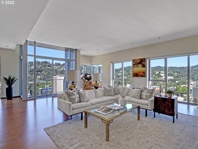 living room with wood-type flooring and expansive windows