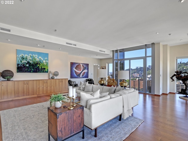 living room with dark hardwood / wood-style floors and expansive windows