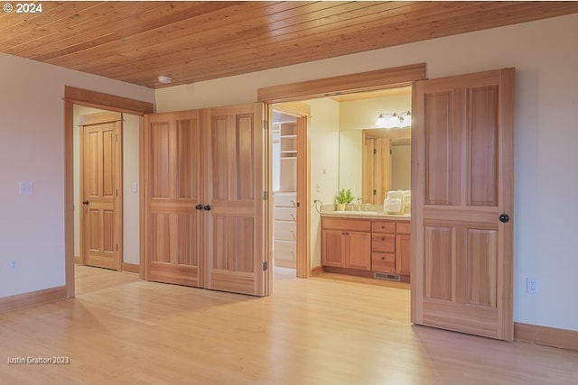 285 23rd St, Astoria, OR 97103 - unfurnished bedroom featuring light wood finished floors, a sink, baseboards, ensuite bathroom, and wood ceiling