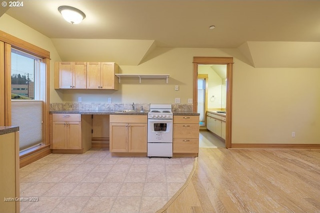 285 23rd St, Astoria, OR 97103 - kitchen with white electric range oven, a sink, vaulted ceiling, light brown cabinetry, and dark countertops