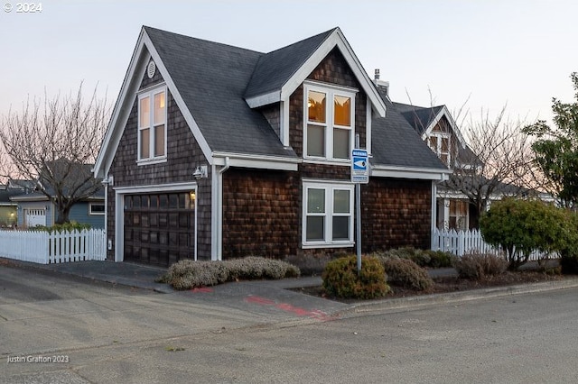 285 23rd St, Astoria, OR 97103 - view of front of property with a chimney, a garage, roof with shingles, and asphalt driveway