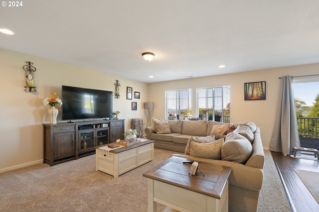 living room with a wealth of natural light and carpet flooring