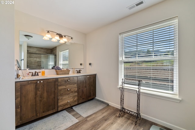 bathroom with a shower with door, wood-type flooring, and vanity