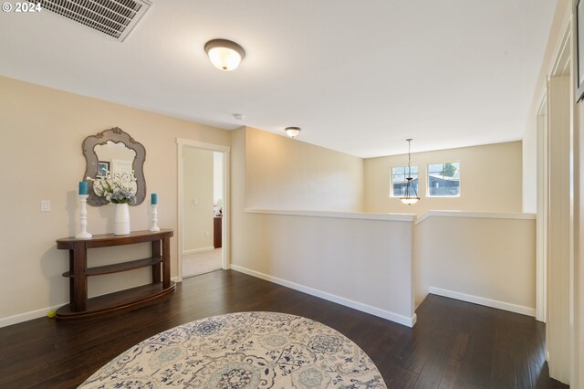 corridor with dark hardwood / wood-style flooring