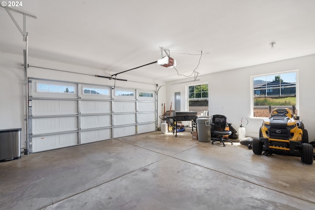 garage with a garage door opener and electric panel