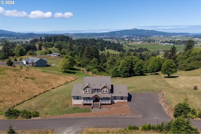 birds eye view of property featuring a mountain view