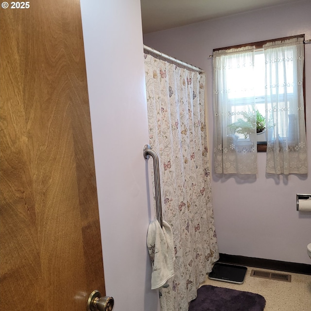 bathroom featuring visible vents and curtained shower