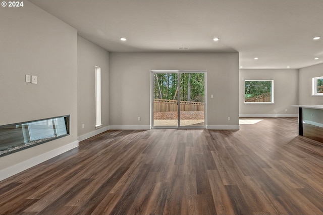 unfurnished living room with dark hardwood / wood-style flooring