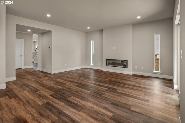 unfurnished living room with dark hardwood / wood-style flooring