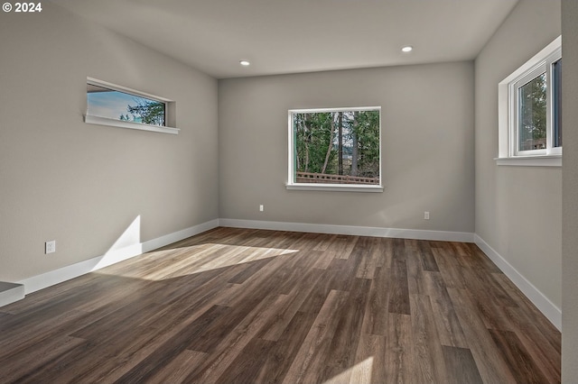 spare room with dark hardwood / wood-style floors