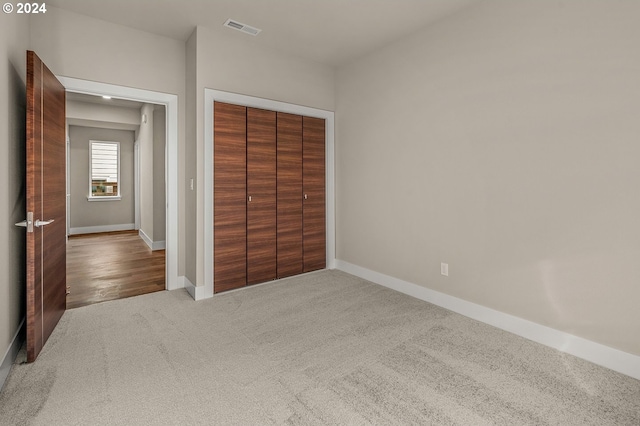 unfurnished bedroom featuring a closet and carpet