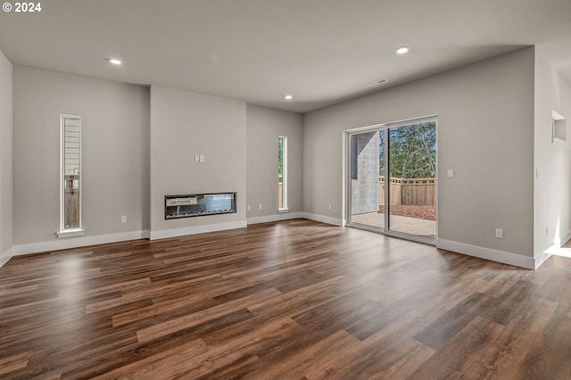 unfurnished living room with dark hardwood / wood-style flooring