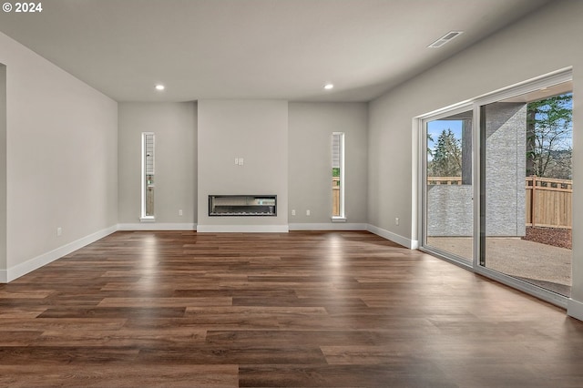 unfurnished living room featuring dark hardwood / wood-style floors