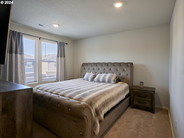 carpeted bedroom with a textured ceiling