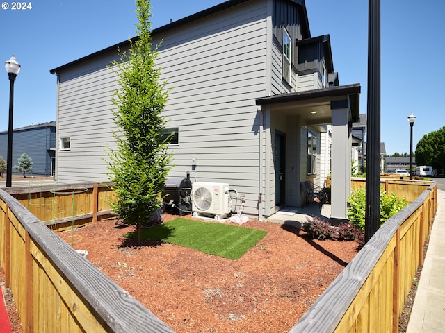 view of side of home featuring ac unit