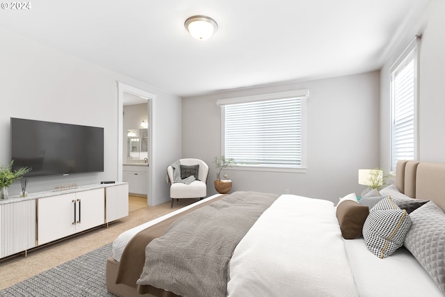 carpeted bedroom featuring ensuite bath