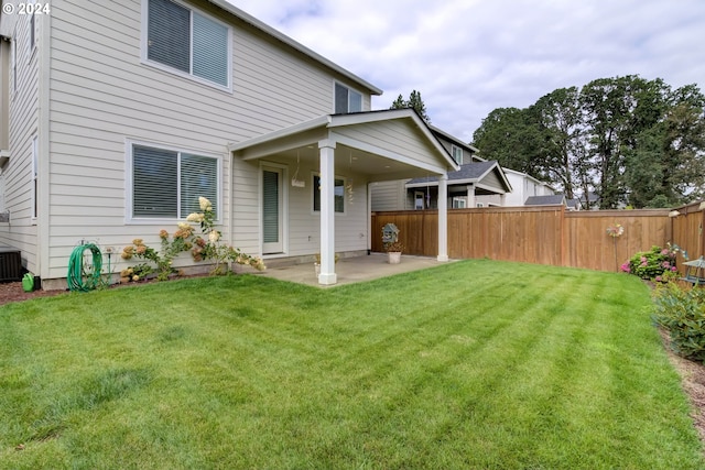 back of property featuring a lawn and a patio area