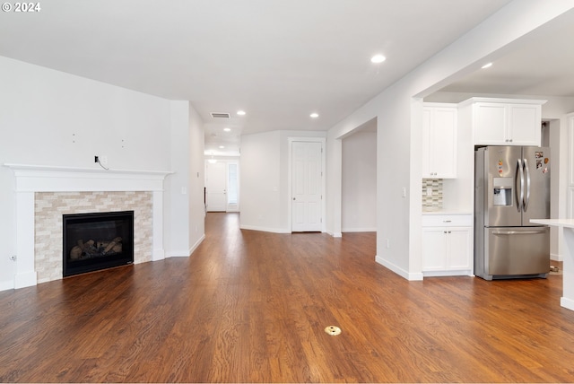 unfurnished living room featuring a fireplace and dark hardwood / wood-style floors