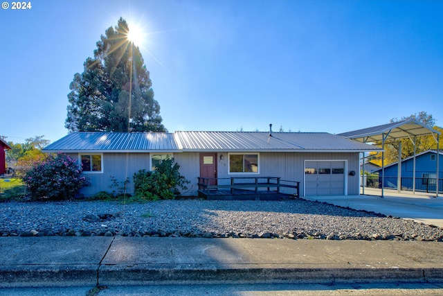 ranch-style house featuring a garage and a carport